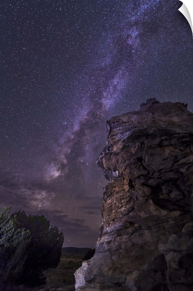 A rocky hoodoo stands against the night sky as the Milky Way sets near Black Mesa, Oklahoma.