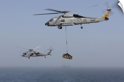 A SH-60J Seahawk and a MH-60S during a vertical replenishment