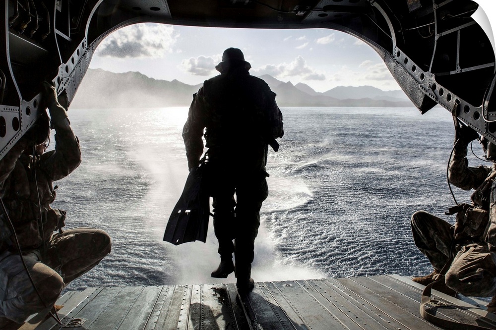 A soldier conducts a combat dive mission off the back of a CH-47 Chinook.