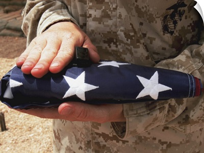 A soldier holds the United States flag