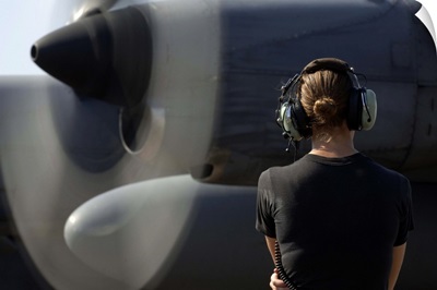 A soldier monitors the performance of a newly repaired C130 Hercules engine