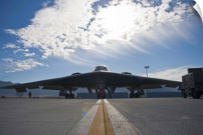 A U.S. Air Force B-2 Spirit is inspected by ground crews