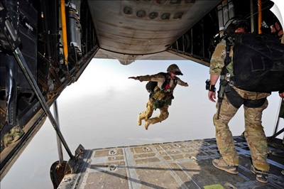 A U.S. Air Force pararescueman jumps out of an HC-130P Combat King aircraft