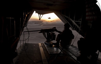 A U.S. Marine provides aerial security from a CH-53E Super Stallion