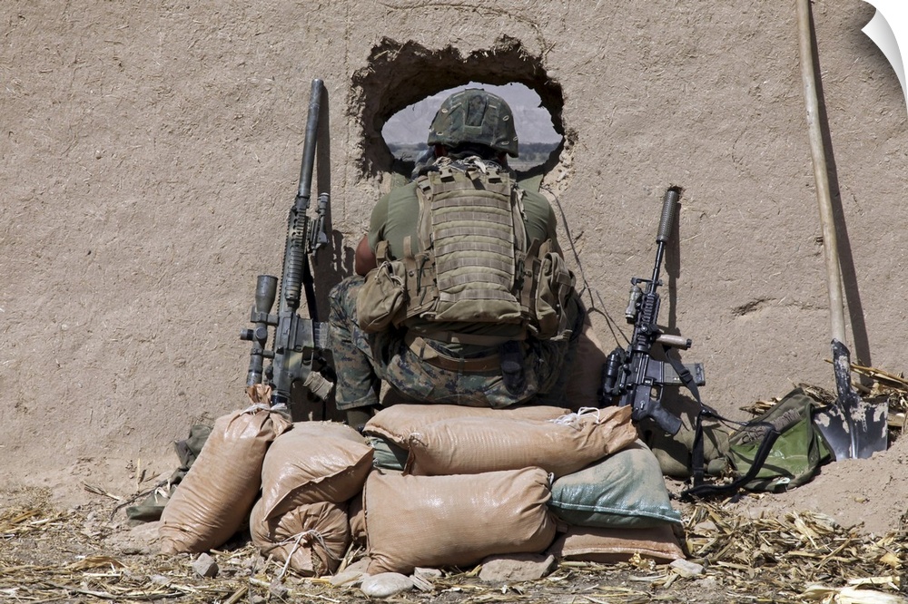 October 14, 2010 - A U.S. Marine sniper observes his sector at a patrol base near Sangin, Afghanistan. The Marines support...
