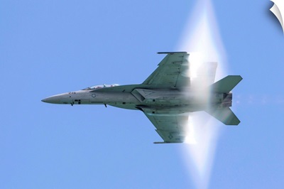 A U.S. Navy F/A-18F Super Hornet flies by at high transonic speed