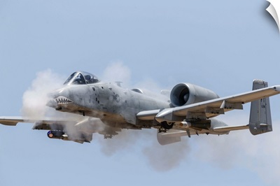 A US Air Force A-10 Thunderbolt II fires its 30mm gun at a strafe target