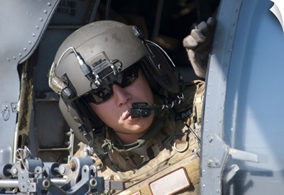 A US Air Force Airman Peers Out The Side Of A HH-60 Pave Hawk