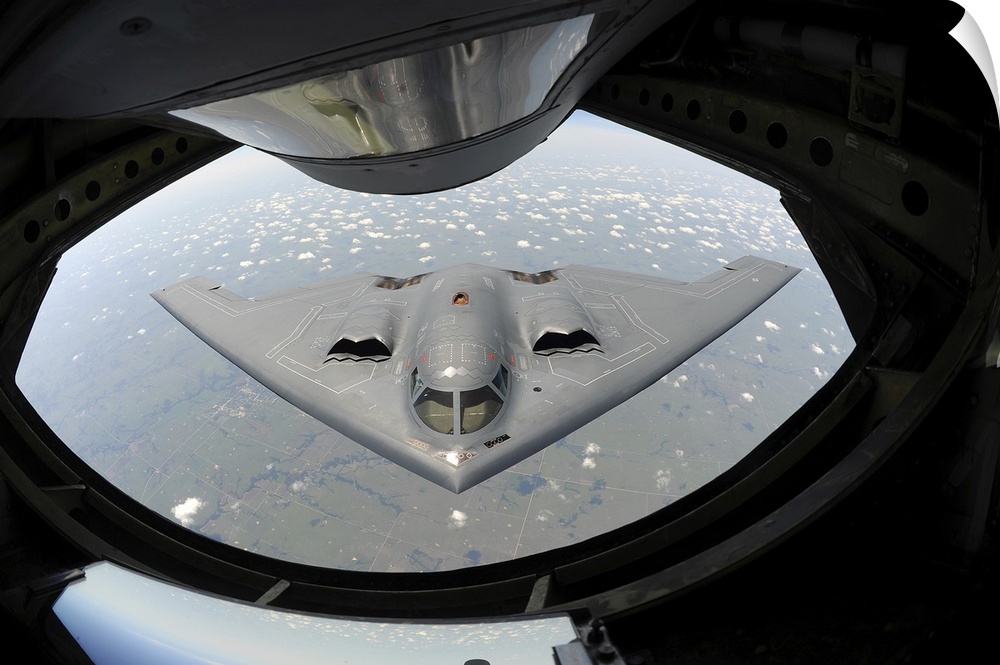 August 1, 2013 - A U.S. Air Force B-2 Spirit bomber aircraft approaches the rear of a KC-135 Stratotanker aircraft before ...