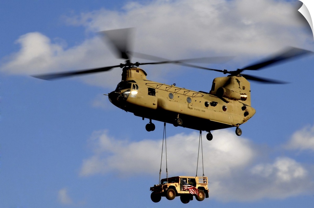 March 4, 2010 - A U.S. Army CH-47 Chinook helicopter transporting a Humvee prepares to land at a forward operating base in...
