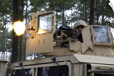 A US Marine Fires A M-240B Machine Gun Atop A Humvee