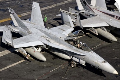 A US Navy F/A-18C Hornet parked on the flight deck of USS Nimitz