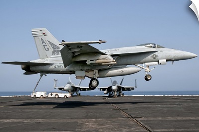 A US Navy F/A-18E Super Hornet prepares to land aboard USS Eisenhower