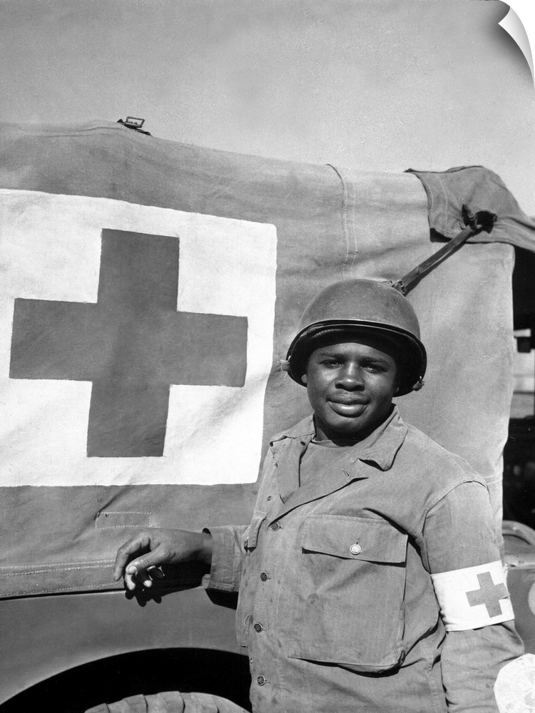 A World War II soldier stands next to his Red Cross vehicle, 1944.