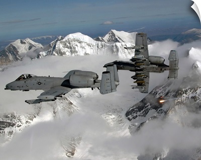 A10 Thunderbolt IIs fly over mountainous landscape