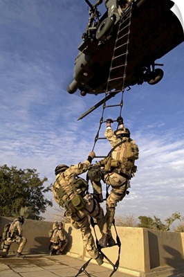 Air Force pararescuemen are extracted by an HH60G Pave Hawk helicopter