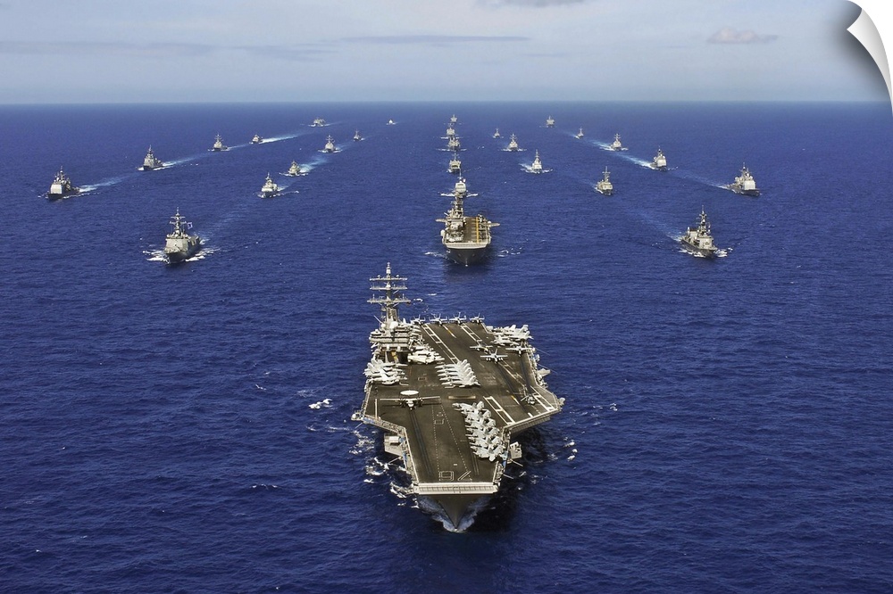 Aircraft carrier USS Ronald Reagan transits the Pacific Ocean with a fleet of ships.