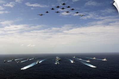 Aircraft fly over a group of US and Japanese Maritime Self-Defense Force ships