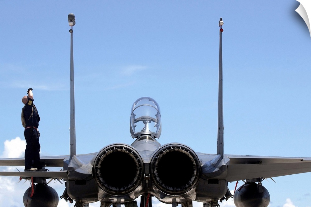 Airman checks an F-15E Strike Eagle for airframe damage.