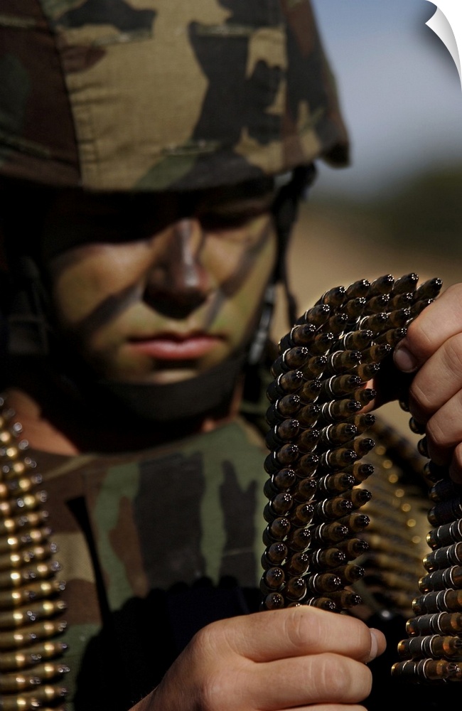 Fort Huachuca, Arizona - Airman loads up ammunition for the M-249 automatic rifle prior to a tactics exercise.