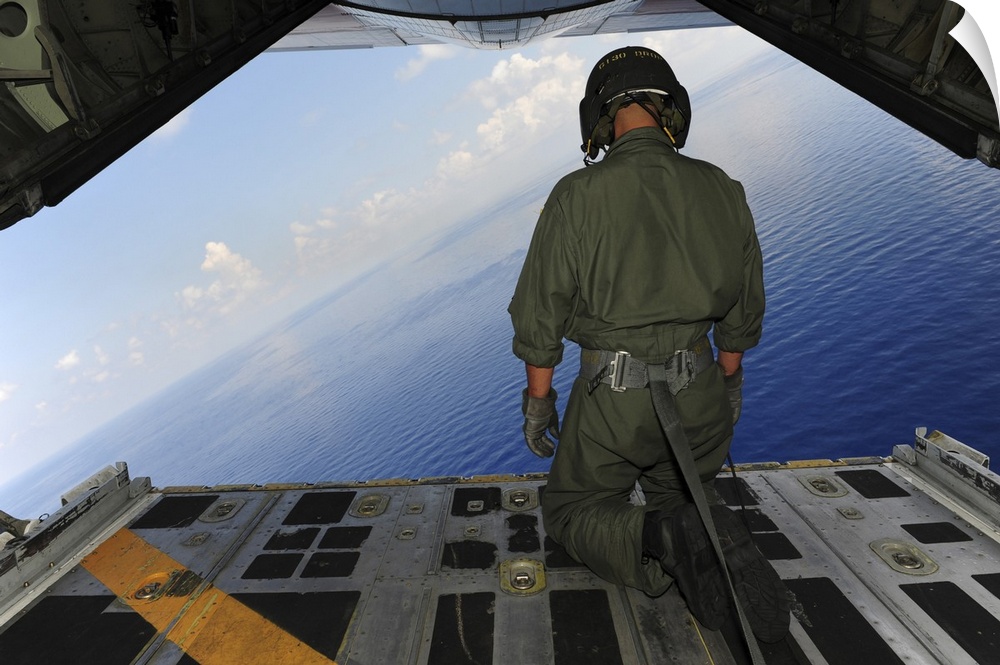 St. Petersburg, Florida, May 29, 2010 - Airman observes the waters of the Gulf of Mexico from a C-130 Hercules. The C-130 ...