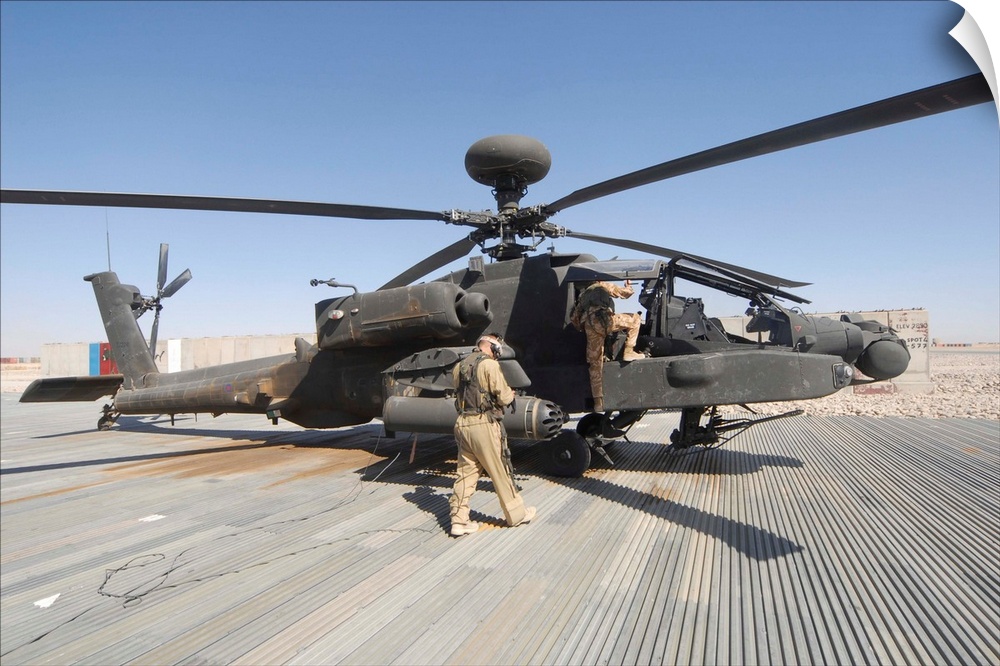 Airmen board an Apache helicopter at Camp Bastion, Afghanistan.
