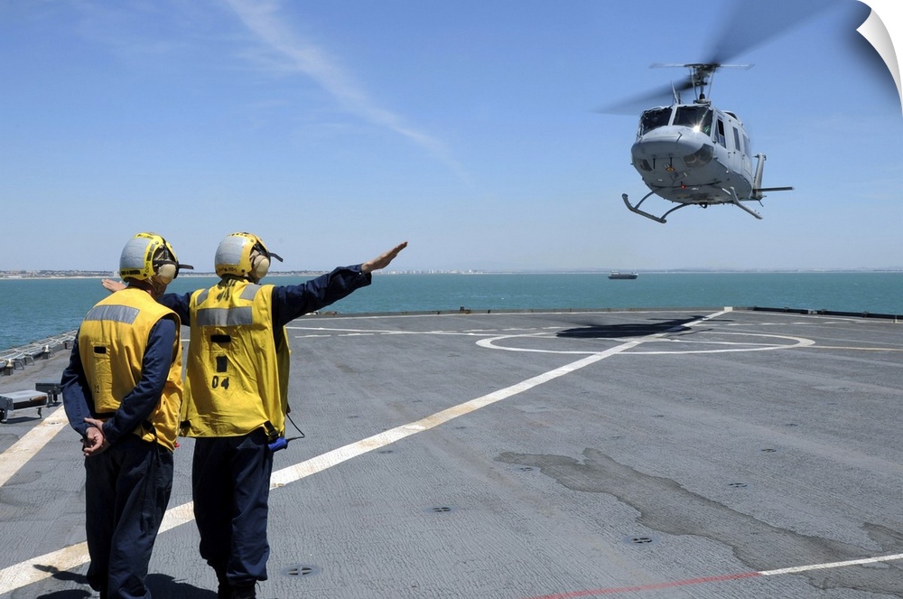 Atlantic Ocean, May 5, 2010 - Airmen direct a Spanish navy AB-212 helicopter onto the flight deck of the amphibious dock l...
