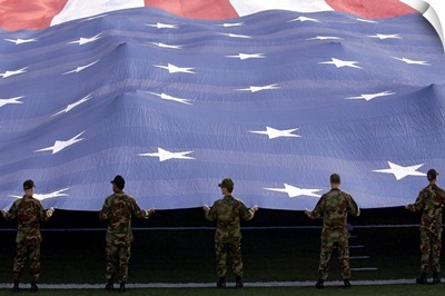 Airmen present the American Flag during the National Anthem