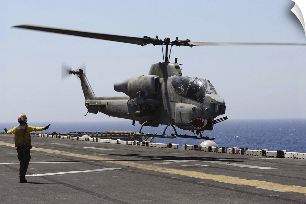 Red Sea, July 23, 2013 - An AH-1W Super Cobra helicopter takes off from the flight deck of the amphibious assault ship USS...