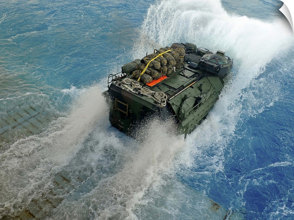 An amphibious assault vehicle exits the well deck of USS Fort McHenry.