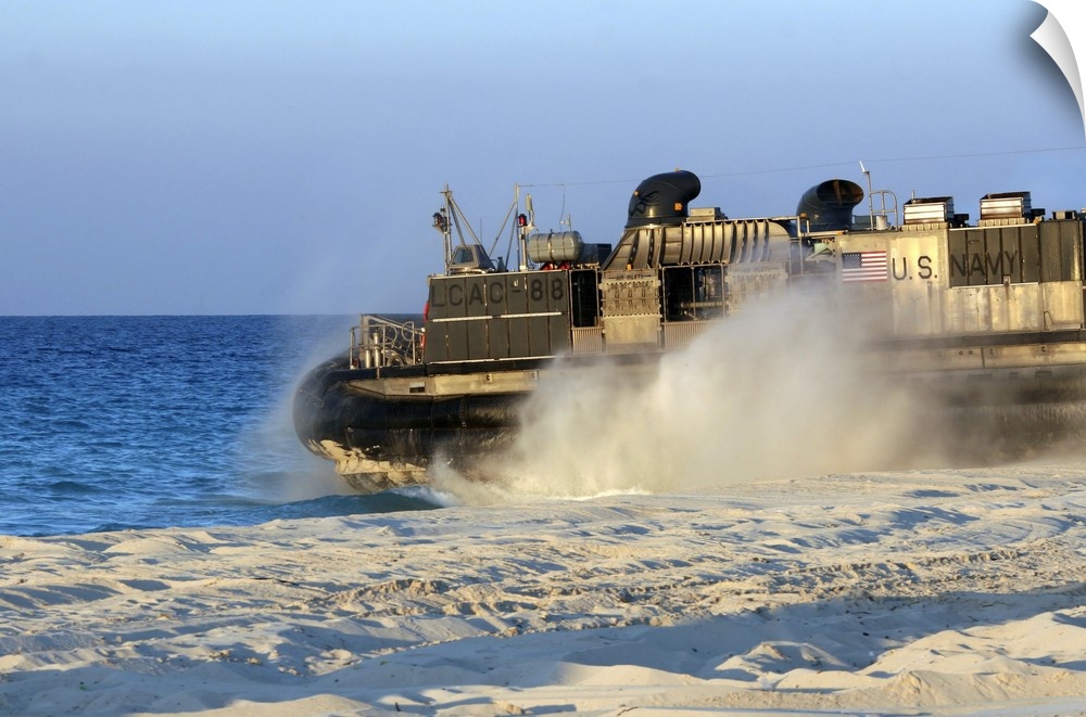 An assault craft heads back to sea after dropping off cargo during an offload.