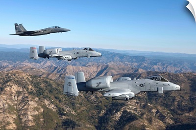 An F-15 Eagle and two A-10 Thunderbolts in flight over Central Idaho
