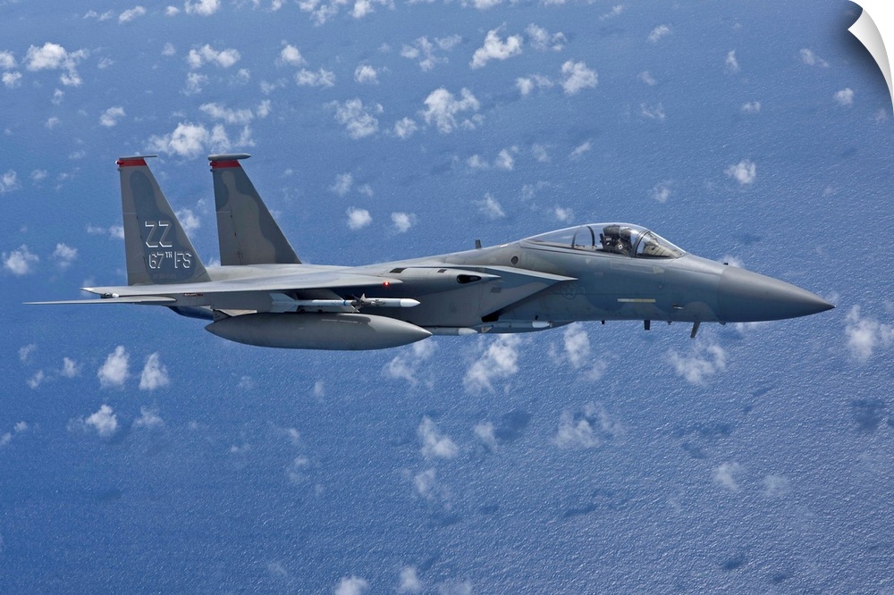 An F-15 Eagle from the 67th Fighter Squadron in Kadena Air Base, Okinawa, Japan, flies over the Pacific Ocean during a tra...