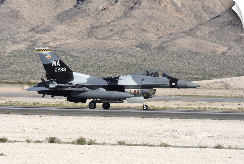 An F-16C Aggressor jet landing on runway in Nevada.