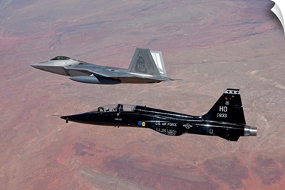 An F-22 Raptor and a T-38 Talon fly in formation over New Mexico
