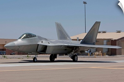 An F-22 Raptor taxies to the runway for a training mission