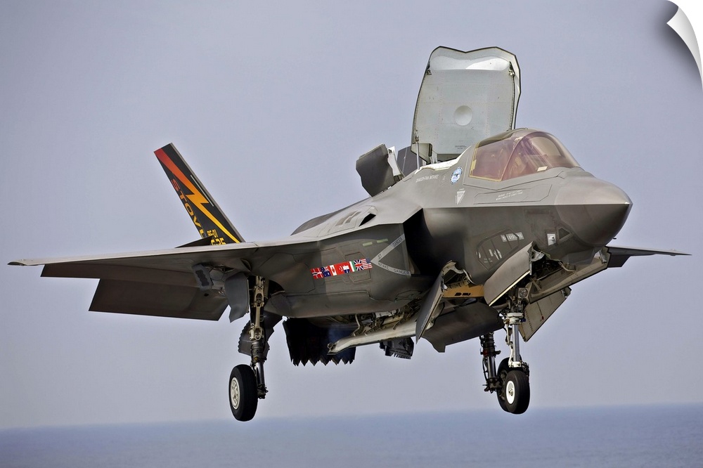 August 27, 2013 - An F-35 Lightning II short take-off/vertical landing aircraft hovers prior to landing on the flight deck...