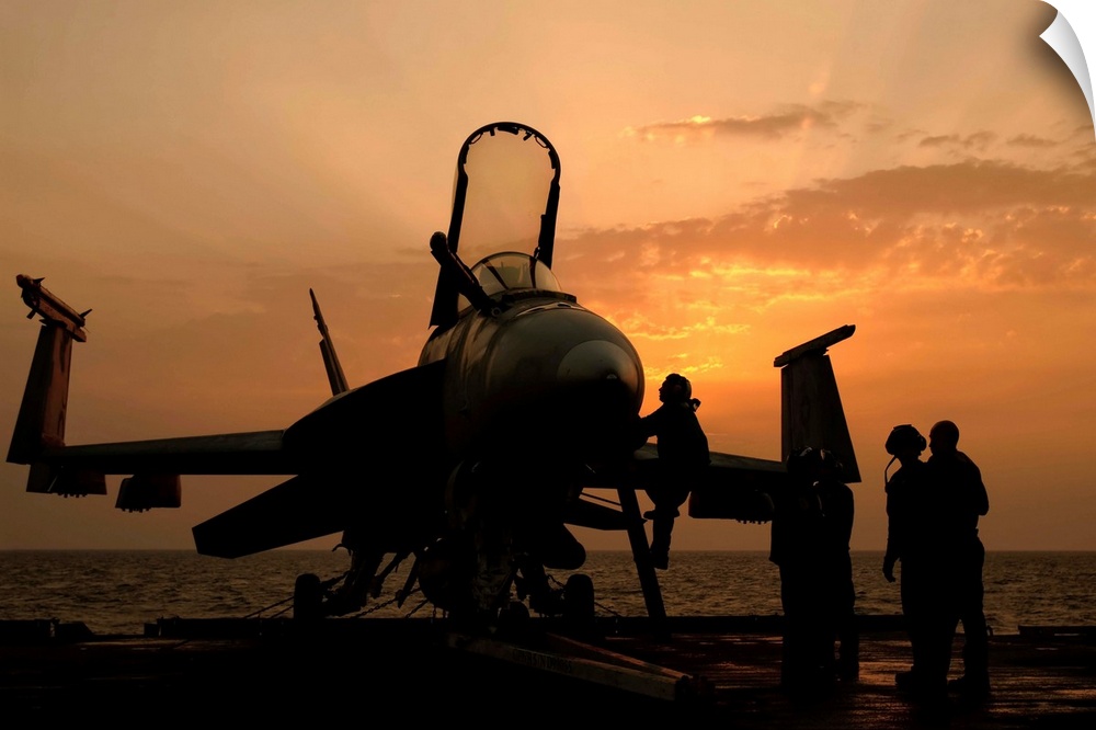 Persian Gulf, October 31, 2011 - An F/18C Hornet aboard USS George H.W. Bush during sunrise.