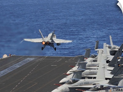 An F/A-18C Hornet launches off the flight deck of USS Dwight D. Eisenhower