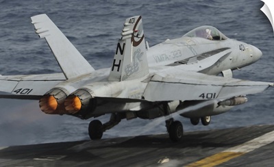 An F/A-18C Hornet launches off the flight deck of USS Nimitz