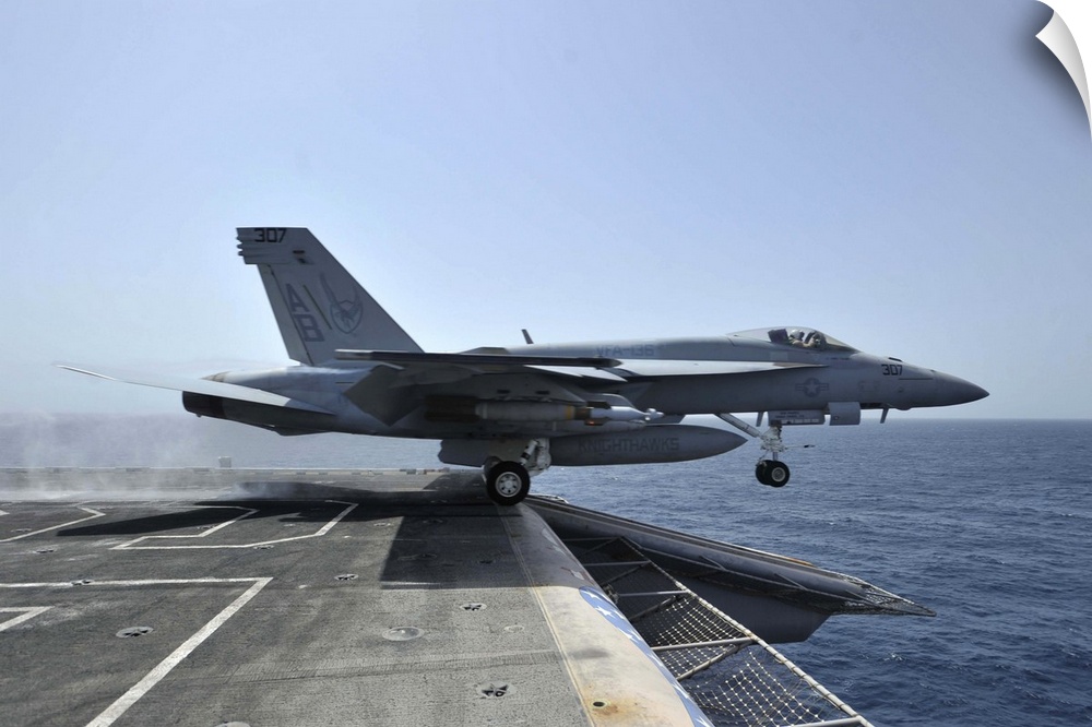 Arabian Sea, March 28, 2011 - An F/A-18E Super Hornet launches from the aircraft carrier USS Enterprise (CVN-65).