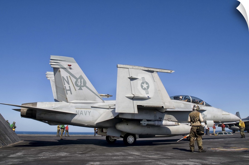 A US Navy F/A-18F Super Hornet moves into launch position aboard aircraft carrier USS Nimitz.