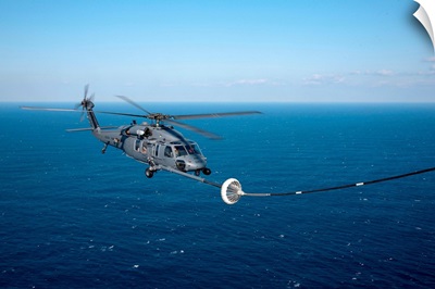 An HH-60 Pave Hawk refuels over the Pacific Ocean