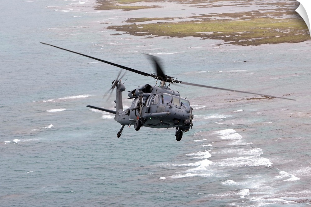 An HH-60G Pave Hawk from the 33rd Rescue Squadron flies along the Okinawa coastline during a training mission out of Kaden...