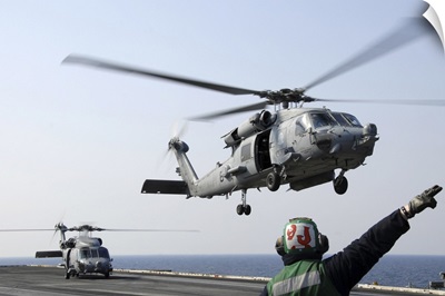 An HH-60H Sea Hawk helicopter takes off from USS Ronald Reagan