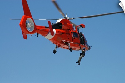 An HH 65C Dolphin demonstrates a helicopter rescue