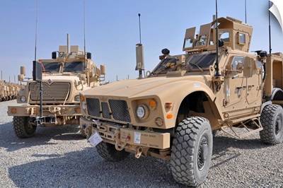 An M ATV Mine Resistant Ambush Protected vehicle parked next to a MaxxPro MRAP