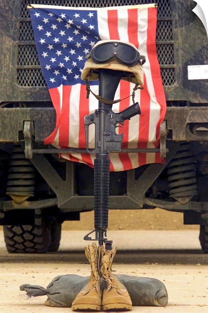 Tall photo on canvas of a rifle sticking out of two boots with a helmet on top in front of an American flag.