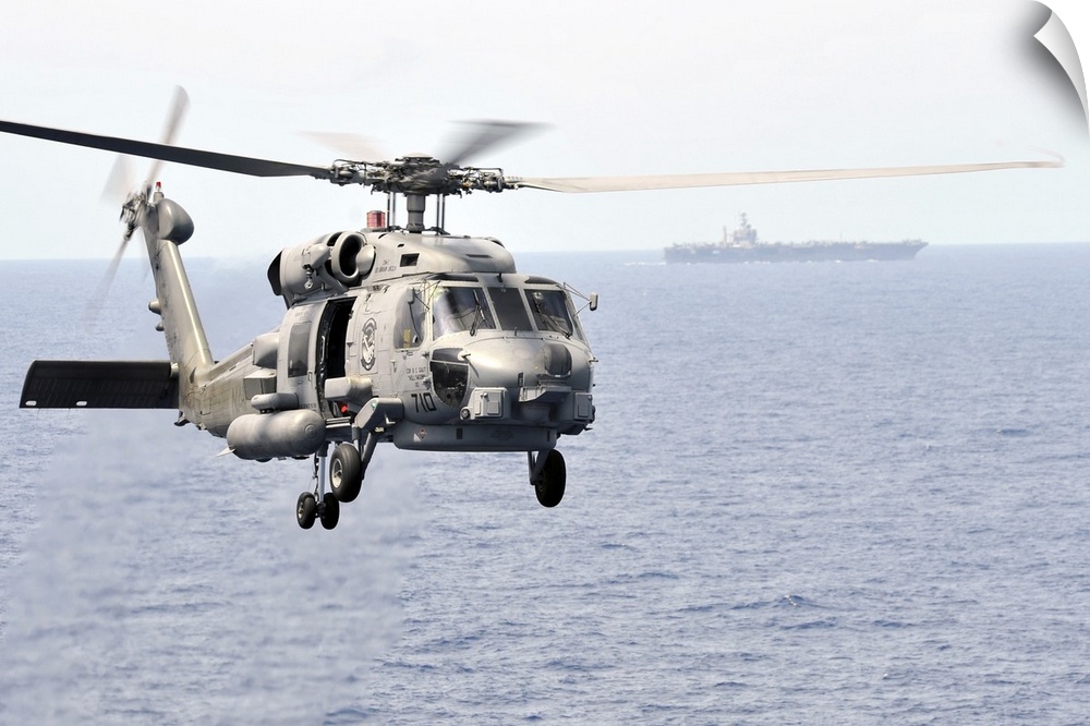 Pacific Ocean, March 9, 2011 - An MH-60R Seahawk helicopter participates in an air power demonstration while embarked aboa...
