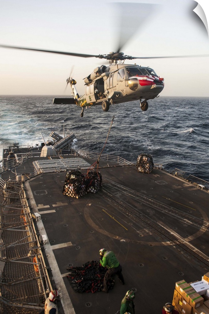 February 16, 2013 - An MH-60S Sea Hawk helicopter delivers cargo to the Ticonderoga-class guided-missile cruiser USS Mobil...